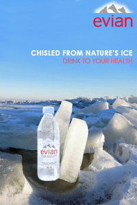 Evian water bottle surrounded by ice.